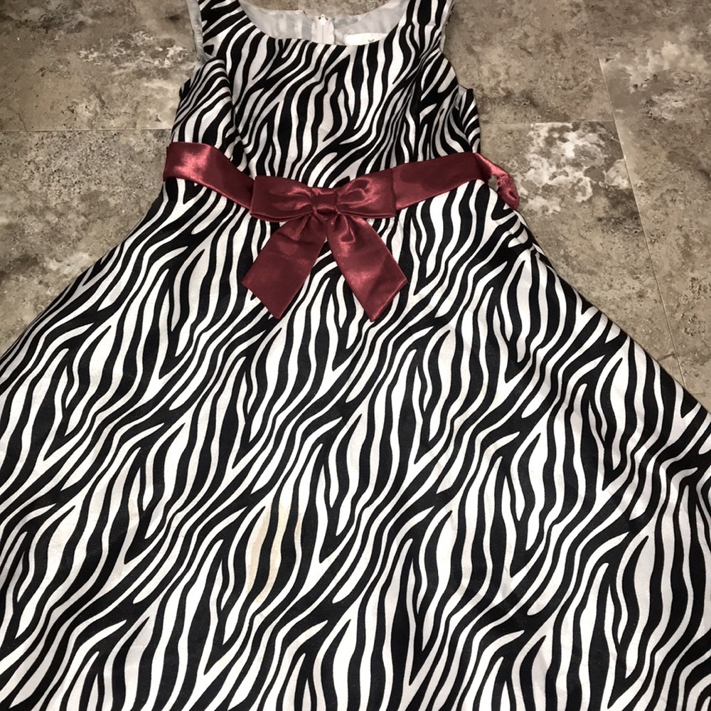 A white and black stripe dress with red ribbon bow